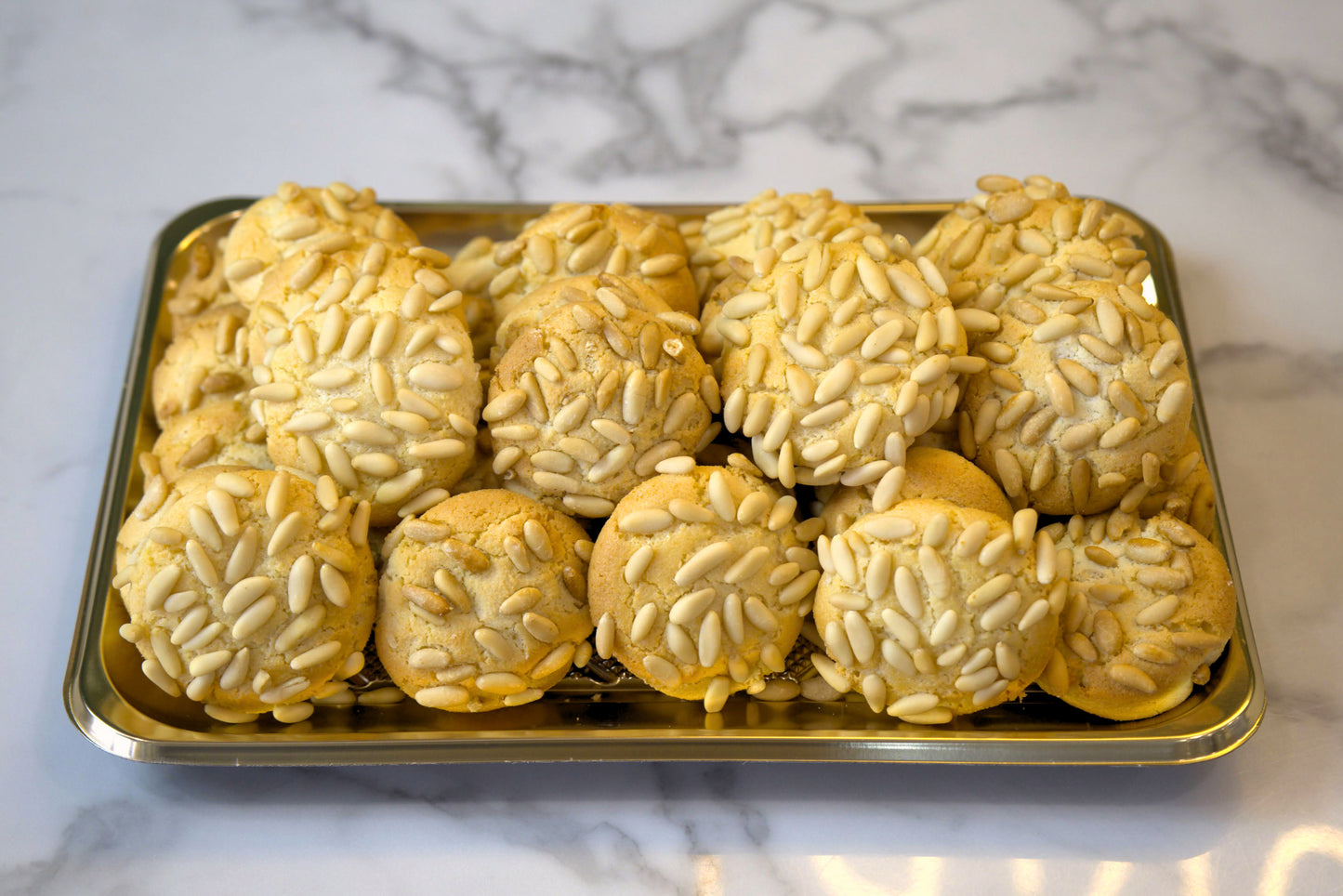 Overhead look at a tray of Pignoli Pine Nut Cookies from La Roma Pastry Shop