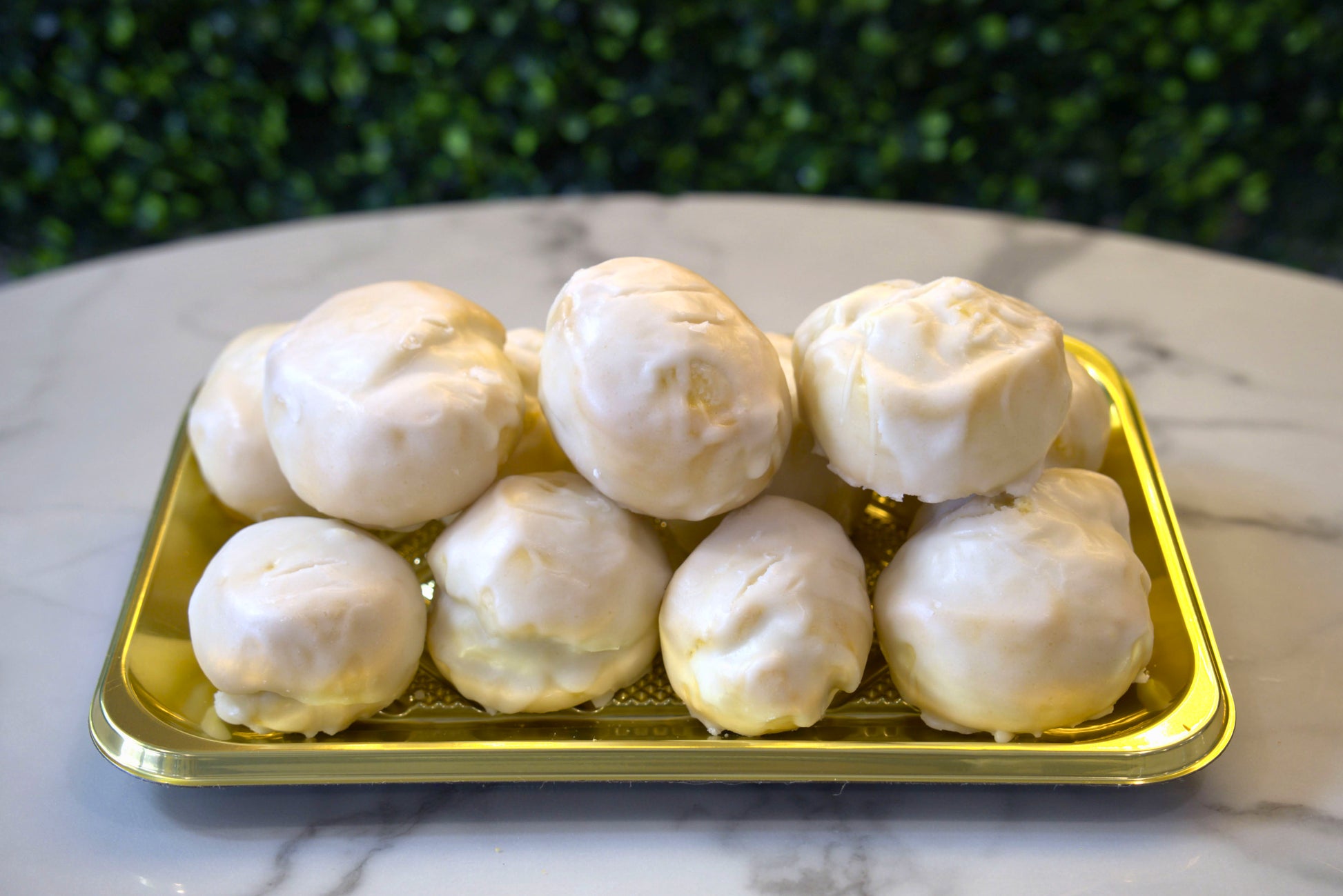 A golden tray filled with Anginetti made by La Roma Pastry Shop
