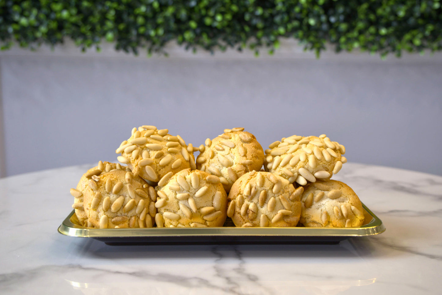 Golden tray of Pignoli Cookies from La Roma Pastry Shop