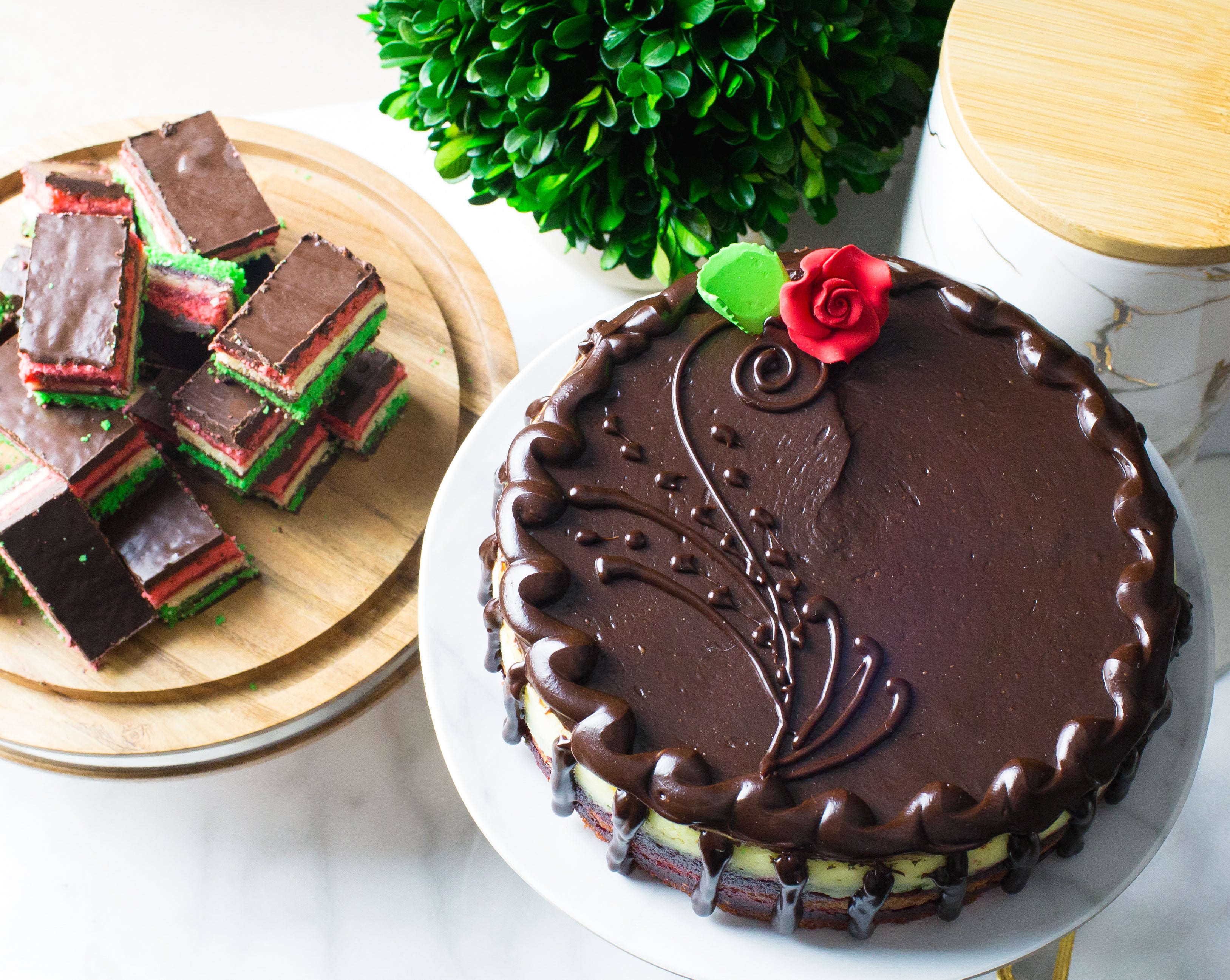 decadent rainbow cookies and cheesecake with chocolate decoration and rose made by la roma pastry shop in oakdale new york