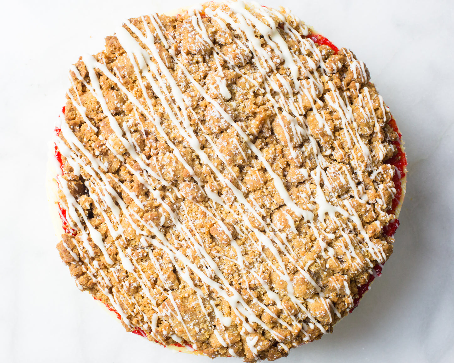 overhead shot of new york bakery la roma pastry shops raspberry crumb cheesecake with glaze drizzle 