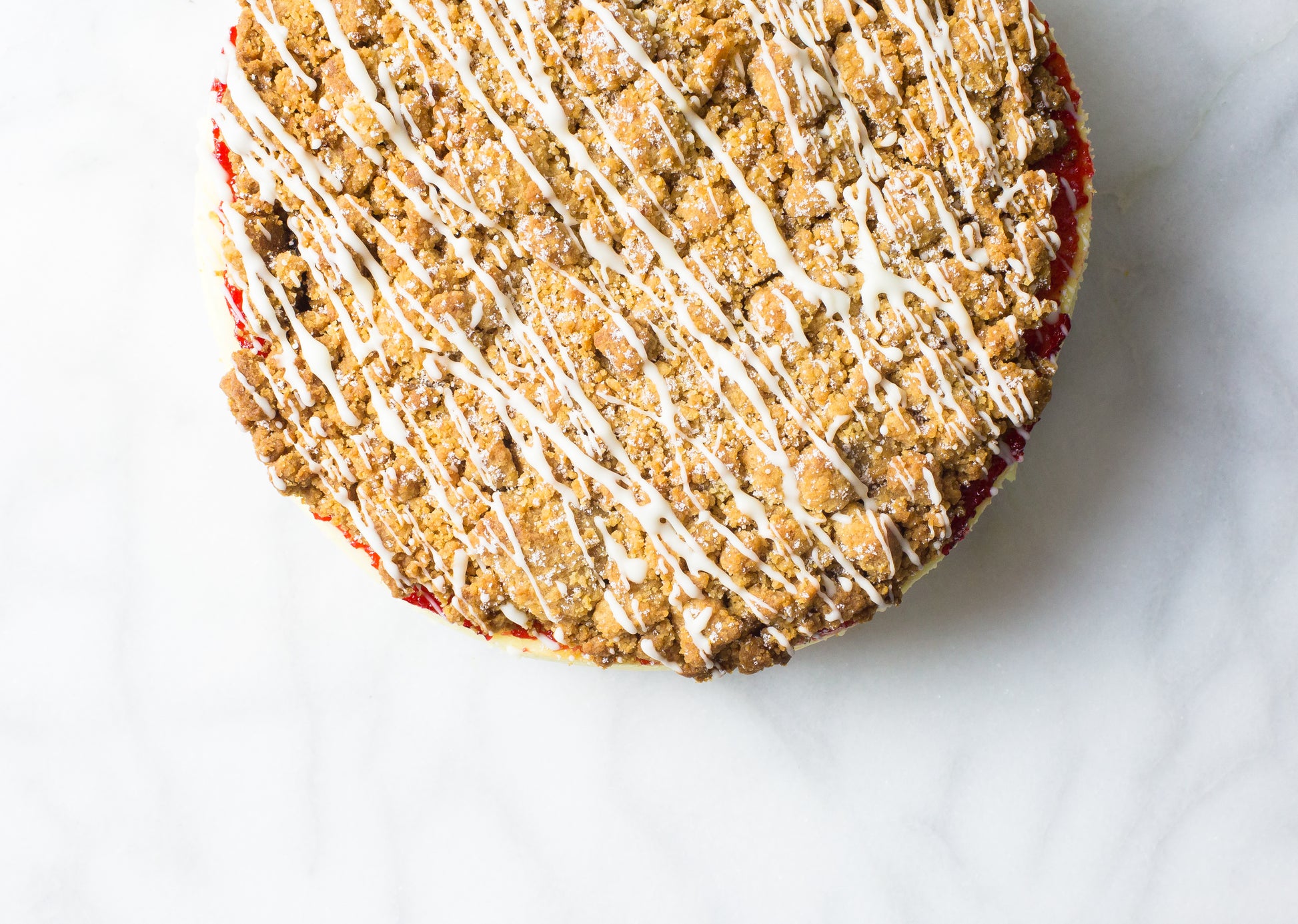 raspberry crumb cheesecake with glaze drizzle made on long island by la roma pastry shop